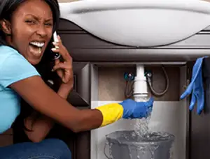 Emergency plumbing repair for a leaking sink drain under a bathroom vanity in Las Vegas, NV