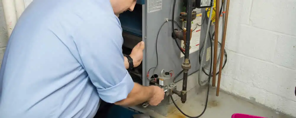 Furnace repair technician inspecting and servicing a home heating system in Las Vegas, NV