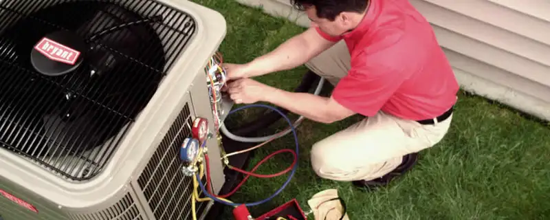 HVAC technician servicing an outdoor air conditioner unit in Las Vegas, NV