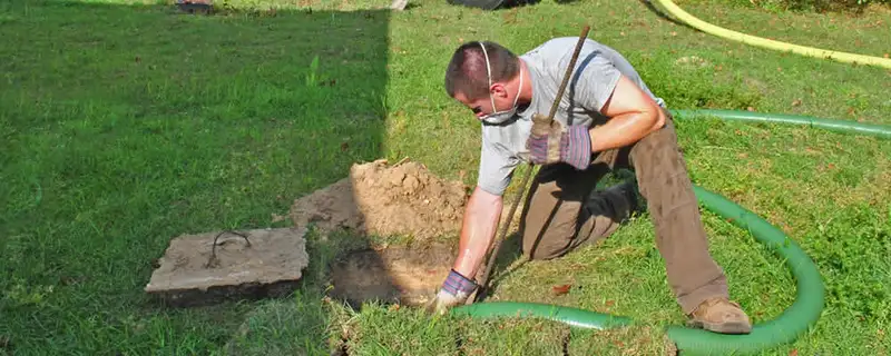 Septic pumping technician servicing a residential septic tank in Las Vegas, NV