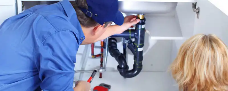 Plumber repairing under-sink drain pipes and fittings in Las Vegas, NV
